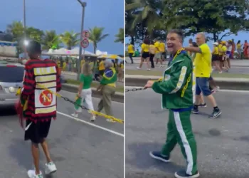 Homem negro acorrentado durante ato político na Barra da Tijuca.